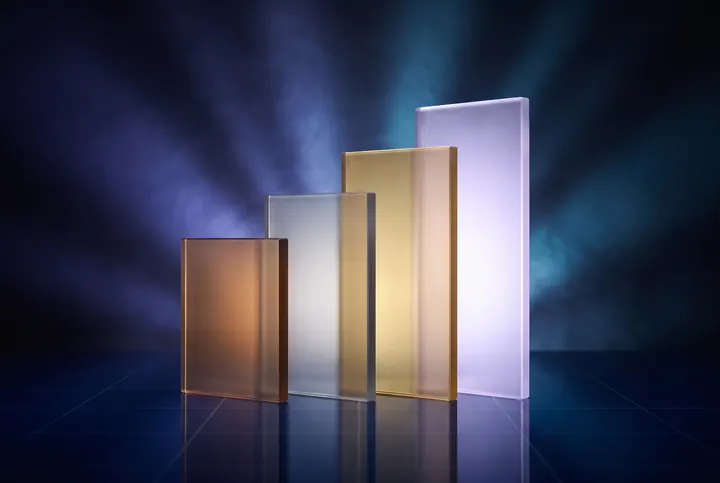 Four translucent glass slabs of ascending height lit in bronze, silver, gold and violet